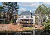 Spacious brick home with a full rear porch overlooking a lake, beautiful outdoor living at 6191 Talmadge Run, Acworth, GA 30101