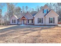 Brick home with a covered porch and landscaped yard at 211 Iroquois Ct, Covington, GA 30014