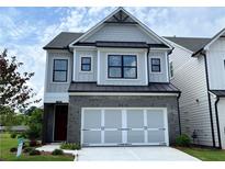 Charming two-story home featuring a brick front, two-car garage, and classic architectural details at 1059 Crest Mill Dr, Marietta, GA 30008