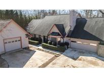 Two-story house with attached garage and large driveway at 5479 Dorsett Shoals Rd, Douglasville, GA 30135