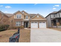 Charming two-story home with a brick and siding exterior and an attached two-car garage at 5480 Beaver Ridge Dr, Cumming, GA 30040