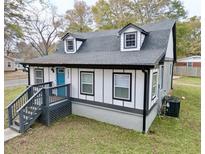 Charming craftsman style home with gray exterior, blue door and landscaping at 2933 5Th Sw St, Atlanta, GA 30315