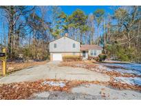 Charming two-story home with a well-maintained front yard, driveway, and beautiful surroundings at 3332 Fannin Ct, Lithonia, GA 30038