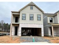 Two-story home with gray siding, black windows, and a two-car garage at 1074 Crest Mill Dr, Marietta, GA 30008