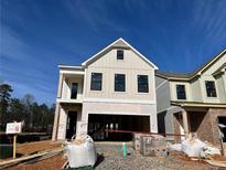 Two-story house under construction, beige siding, black windows, and a two-car garage at 1074 Crest Mill Dr, Marietta, GA 30008