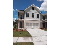 Charming two-story home with a brick facade, covered porch, and a two-car garage at 1074 Crest Mill Dr, Marietta, GA 30008