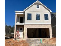 Two-story house with beige siding, brick bottom, and a two-car garage at 1074 Crest Mill Dr, Marietta, GA 30008