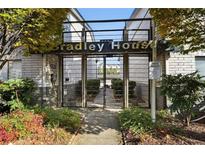 Welcoming entrance to Bradley House, featuring a gated walkway and landscaping at 3501 Roswell Road Ne Rd # 110, Atlanta, GA 30305