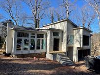 Modern two-story home with large windows and attached garage at 211 Marquis Sw Ct, Lilburn, GA 30047