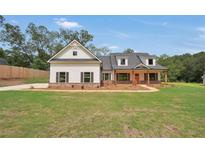 Craftsman style home with white siding, brown accents, and a covered porch at 555 Highway 155, Mcdonough, GA 30252