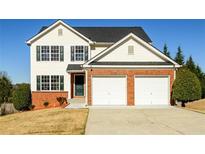 Charming two-story home featuring a two-car garage and well-maintained front yard at 1188 Pine Acre Dr, Sugar Hill, GA 30518