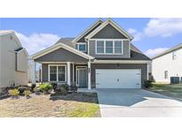 Charming two-story home with gray siding, white trim, and an attached two-car garage at 2349 Hanover Woods Rd, Lithonia, GA 30058