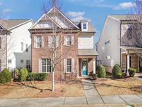 Brick front two-story home with teal door and manicured lawn at 4343 Ainsley Mill Ln, Duluth, GA 30097