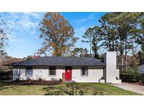 Charming ranch home with freshly painted exterior and landscaped lawn at 2398 Woodland Nw Dr, Kennesaw, GA 30152