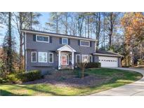 Two-story gray house with a white door, attached garage and landscaped yard at 3429 Clubland Dr, Marietta, GA 30068