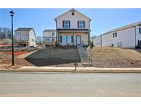 Charming two-story home with a landscaped front yard and inviting entrance staircase at 4750 Hemingway Trl, Cumming, GA 30041