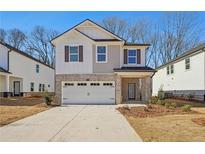Two-story brick home with a white garage door and landscaping at 4755 Marjorie Dr, Cumming, GA 30041