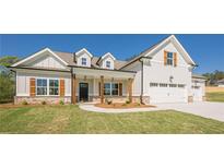 Beautiful two-story home featuring a manicured lawn, white siding and a welcoming two car garage at 30 Pinewood Dr, Covington, GA 30014