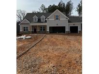 Charming new construction home with a two car garage and unfinished landscaping at 30 Pinewood Dr, Covington, GA 30014