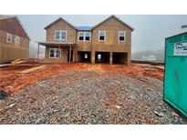 Exterior elevation of a new two-story house under construction with wood and several windows at 305 Bianca Way, Mcdonough, GA 30253