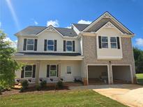 Two-story home boasts a two-car garage and classic architectural details at 1637 Fuma Leaf Way, Mcdonough, GA 30253