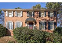 Brick house with shutters, landscaping, and a covered entryway at 809 Commons Ct, Woodstock, GA 30189