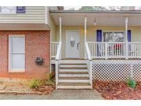 Inviting front porch with white railings and steps leading to the entrance at 370 Charlyne Way, Dacula, GA 30019