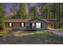 Charming single-story home featuring a welcoming front porch and a convenient carport at 4212 Anneewakee Rd, Douglasville, GA 30135