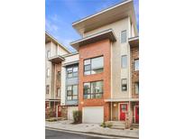 Modern townhouse showcasing a brick facade, sleek windows, and a convenient one-car garage at 966 Moda Dr, Atlanta, GA 30316