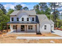 New construction farmhouse-style home with white siding and a welcoming front porch at 10350 Alvin Road, Alpharetta, GA 30022