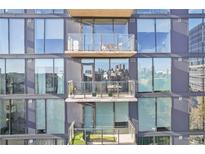 Modern condominium with large windows and outdoor balconies with seating areas at 788 W Marietta Nw St # 403, Atlanta, GA 30318