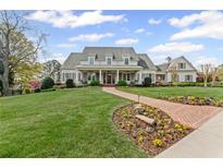 Stunning two-story home with a manicured lawn and a charming brick walkway leading to the entrance at 710 Cox Rd, Roswell, GA 30075