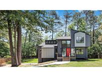 Modern two-story home with gray and white exterior, nestled among trees at 3483 Winter Chase Dr, Marietta, GA 30062