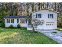 Charming two-story home with a well-maintained lawn and a two-car garage at 3090 Karen Ne Ln, Marietta, GA 30062