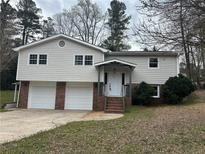 Charming two-story home with a brick-accented two-car garage and inviting front porch at 3967 Evelyn Dr, Powder Springs, GA 30127