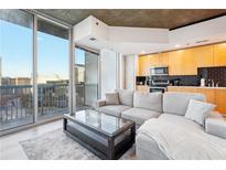 Bright living room featuring floor-to-ceiling windows and an open kitchen with stainless steel appliances at 3324 Peachtree Ne Rd # 1503, Atlanta, GA 30326