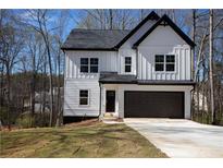 Charming new construction with white siding, black trim, and a two-car garage at 101 Azalea Dr, Villa Rica, GA 30180