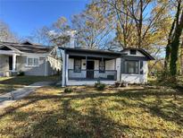 Charming white brick home with gray trim and a covered porch at 880 Cascade Sw Rd, Atlanta, GA 30311