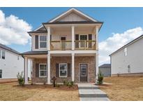 Charming two-story home featuring a welcoming front porch and a second-story balcony at 1230 Firefly Field Trce, Lawrenceville, GA 30045