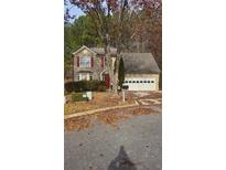 Traditional two-story home with a two-car garage and front yard with a tree at 113 Ambridge Ct, Lawrenceville, GA 30044