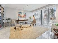 Bright living room featuring large windows, a glass table, and a built in bookshelf at 147 15Th Ne St # 10C, Atlanta, GA 30309