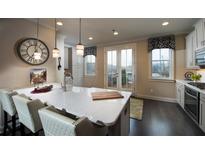 Bright kitchen featuring white cabinets, quartz counters, island with seating, and stainless steel appliances at 2551 High Brow St # 39, Duluth, GA 30096