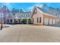 Brick home with a large driveway and three-car garage at 239 Trail Nw Rd, Marietta, GA 30064