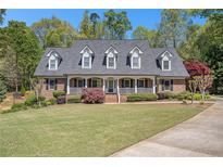 Charming brick home with a welcoming front porch and well-manicured lawn at 510 Jenna Trl, Mcdonough, GA 30252