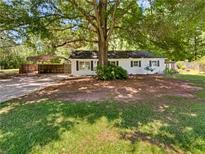 Charming single-story home with a spacious yard and carport offering outdoor living at 30 N Cleveland Church Rd, Mcdonough, GA 30253