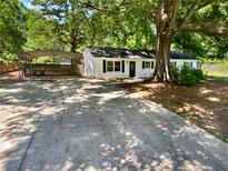 Charming home featuring a carport and a spacious driveway leading to the entrance at 30 N Cleveland Church Rd, Mcdonough, GA 30253