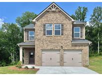 Charming two-story brick home with a two-car garage and well-maintained landscaping at 631 Egrets Lot 50 Lndg, Covington, GA 30014