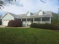 Charming one-story home with a welcoming front porch and well-manicured landscaping at 3825 Green Ave, Loganville, GA 30052