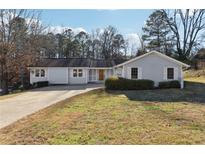 Ranch style home with a landscaped lawn and driveway at 3562 Ontario Ct, Buford, GA 30519