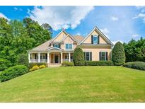 Charming two-story home with a manicured lawn and a welcoming front porch at 3420 Aviary Ln, Acworth, GA 30101